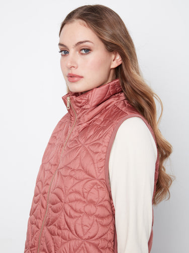 This stylish rosebud-colored puffer vest comes complete with a cozy hood for added warmth and flair by Charlie B.