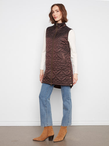Designed with an attached hood, this vest provides extra warmth and protection against the elements. By Charlie B.