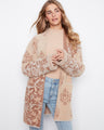 This cozy cardigan features wide sleeves, perfect for a relaxed and comfortable fit. The soft fabric adds an elegant touch by Charlie B.