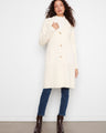 Cream-colored coat with button closure and tailored neckline, perfect for a chic look. By Charlie B.