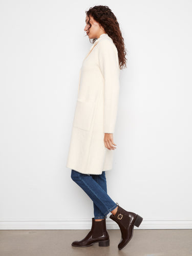 Elegant cream coat featuring patch pockets for added style and functionality. By Charlie B.