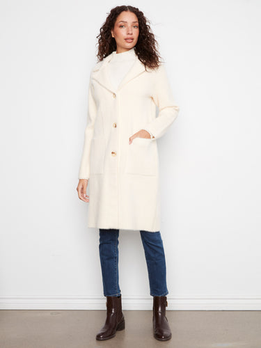 Stylish longline silhouette in a cream hue, ideal for layering over any outfit. By Charlie B.