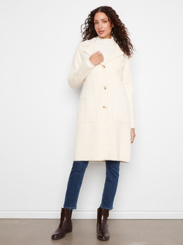 Refined cream coat showcasing a tailored neckline that elevates your ensemble. By Charlie B.