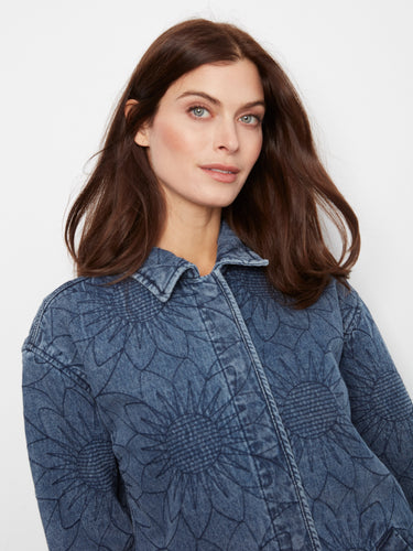 Denim jacket with intricate floral quilting in medium blue, complete with button cuffs and welt pockets for added style by Charlie B.