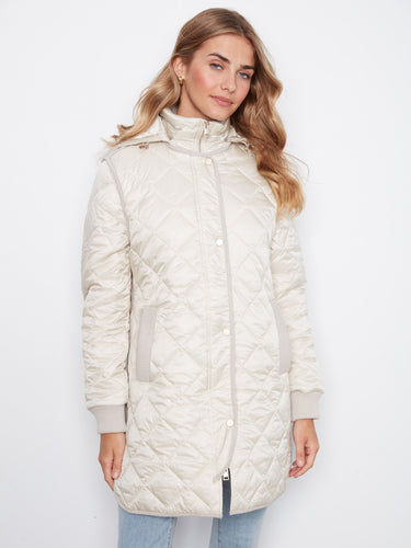 Stylish quilted coat featuring convenient welt pockets for easy storage by Charlie B.