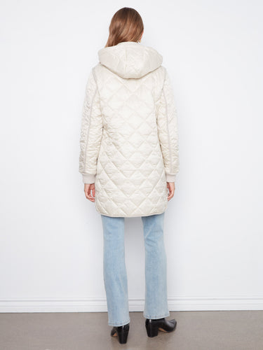 Chic quilted design with a front zip closure complemented by snap buttons for secure wear by Charlie B.