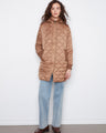 Truffle-colored puffer jacket featuring a removable hood, quilted pattern, and ribbed cuffs. Zip closure adds style by Charlie B.
