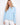 Light blue scuba top with a crew neckline, featuring intricate soutache detailing on the sleeves. Relaxed fit by Charlie B.