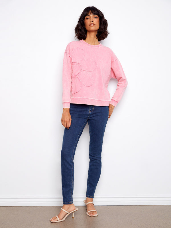 Stylish pink sweatshirt with flower applique design, perfect for adding a playful touch to your wardrobe by Charlie B.