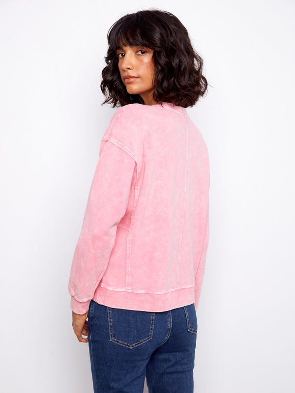 Chic pink sweater featuring unique design elements like drop shoulders for added flair in any outfit by Charlie B.