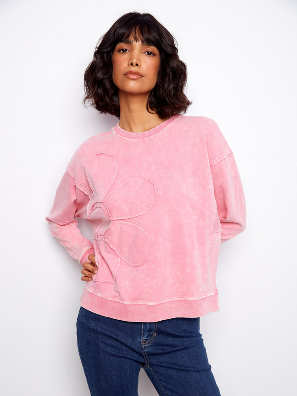 Beautifully designed pink top with crew neckline offers timeless elegance and comfort in one piece by Charlie B.