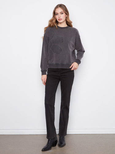 Charcoal top with ribbed neck, hem, and cuffs paired with floral applique by Charlie B.