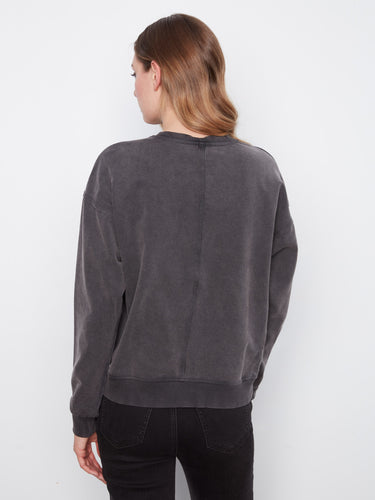 Sophisticated charcoal piece featuring a crew neckline and unique floral detail by Charlie B.