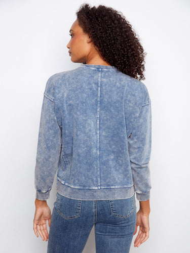 This stylish blue sweatshirt showcases ribbed details on the neck and cuffs for added texture and appeal by Charlie B.