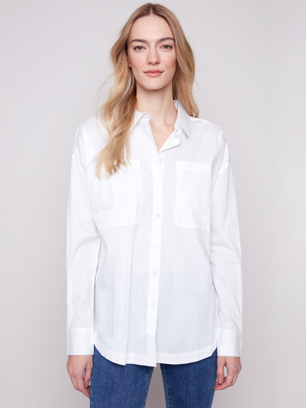 Crisp white poplin shirt designed with button cuffs and long sleeves for added elegance by Charlie B.