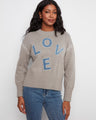 Sweater featuring a mock neck design with denim LOVE appliqué, perfect for a casual yet stylish look by Charlie B.