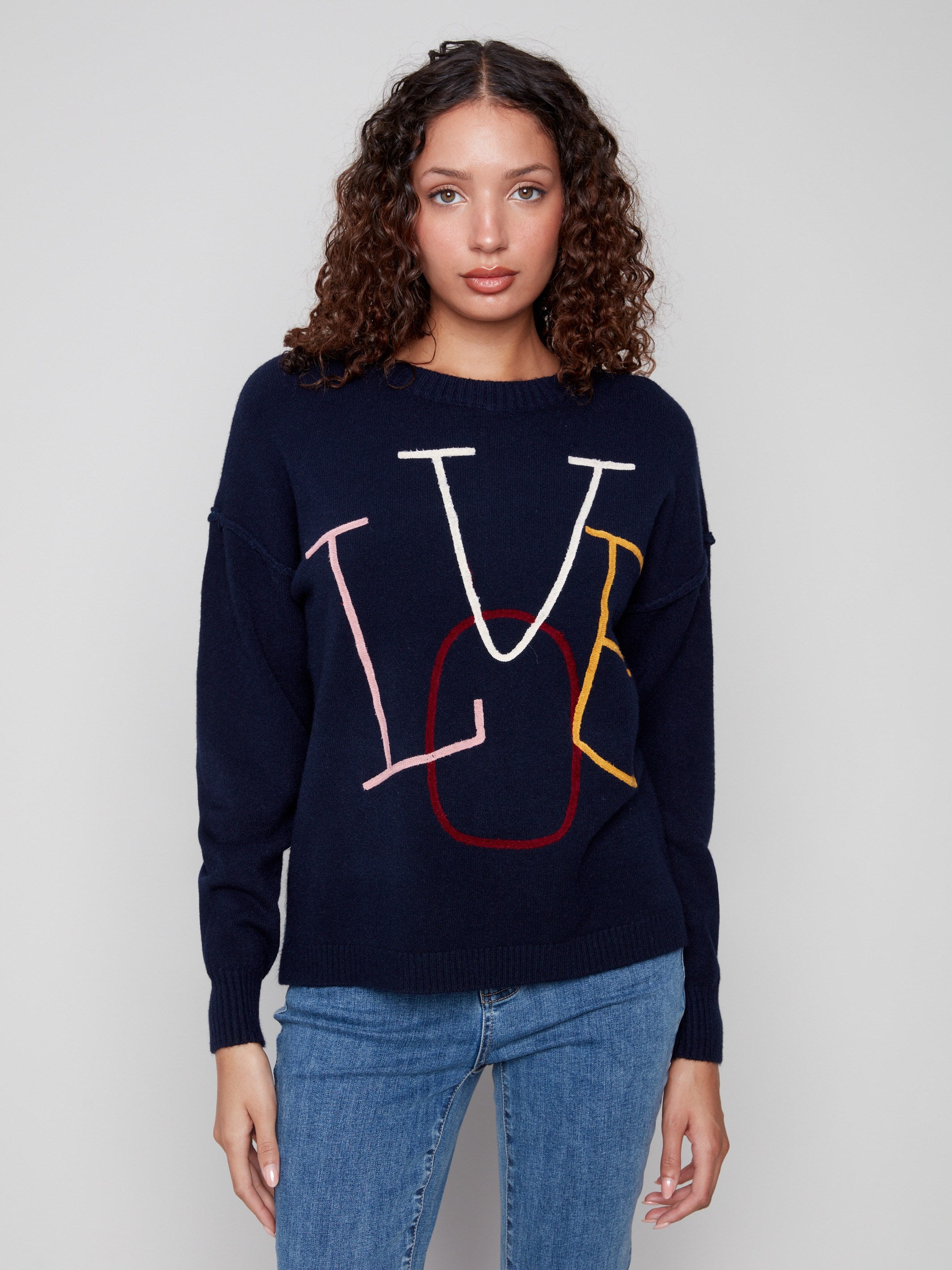 Navy sweater with colorful 'LOVE' embroidery, showcasing a relaxed drop shoulder fit and ribbed cuffs for added style by Charlie B.