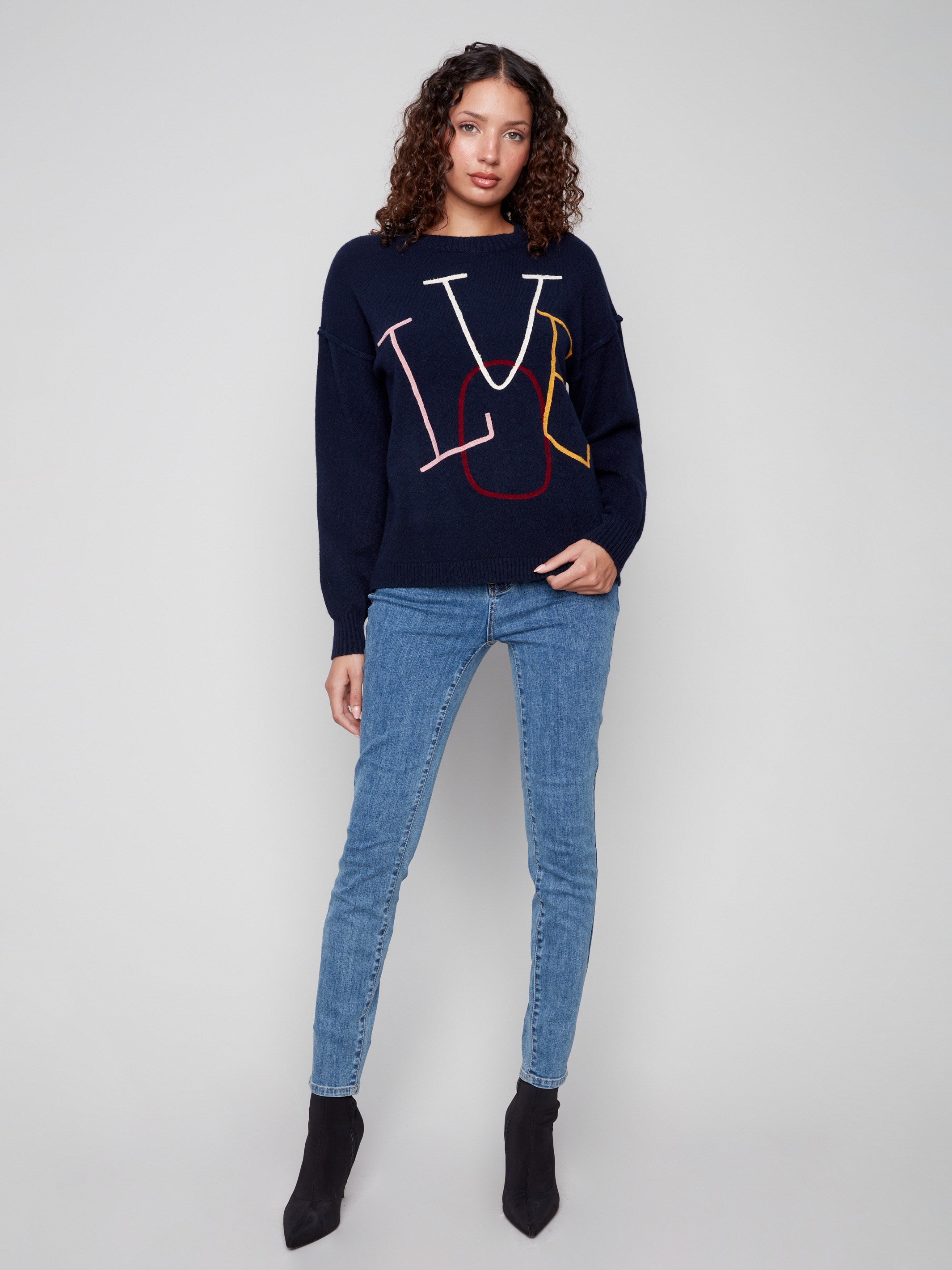 Embrace the crew neck elegance with this navy sweater featuring vibrant 'LOVE' embroidery and a cozy drop shoulder cut by Charlie B.