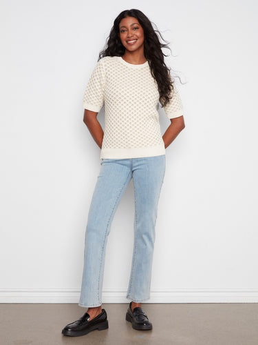 The metallic honeycomb knit adds a touch of elegance and texture to this versatile piece, making it a wardrobe essential. By Charlie B.