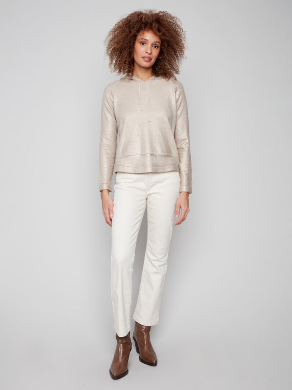 This metallic knit sweater showcases a subtle sheen, adding a touch of glamour to your wardrobe by Charlie B.