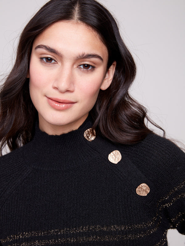 Chic mock neck sweater in black with intricate button details and metallic accents throughout by Charlie B.