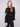 Black sweater featuring a mock neck and floral soutache embroidery, highlighting its relaxed fit by Charlie B.
