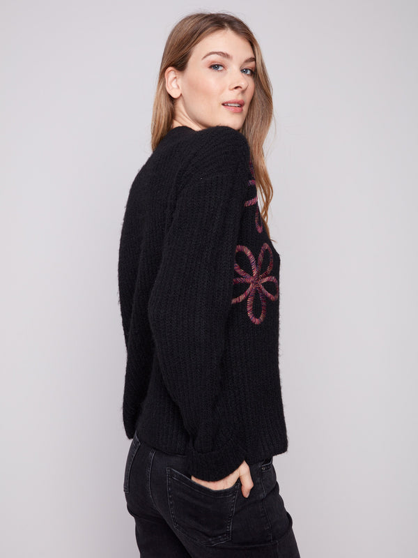 Chic black sweater showcasing a mock neck design with intricate floral soutache accents by Charlie B.