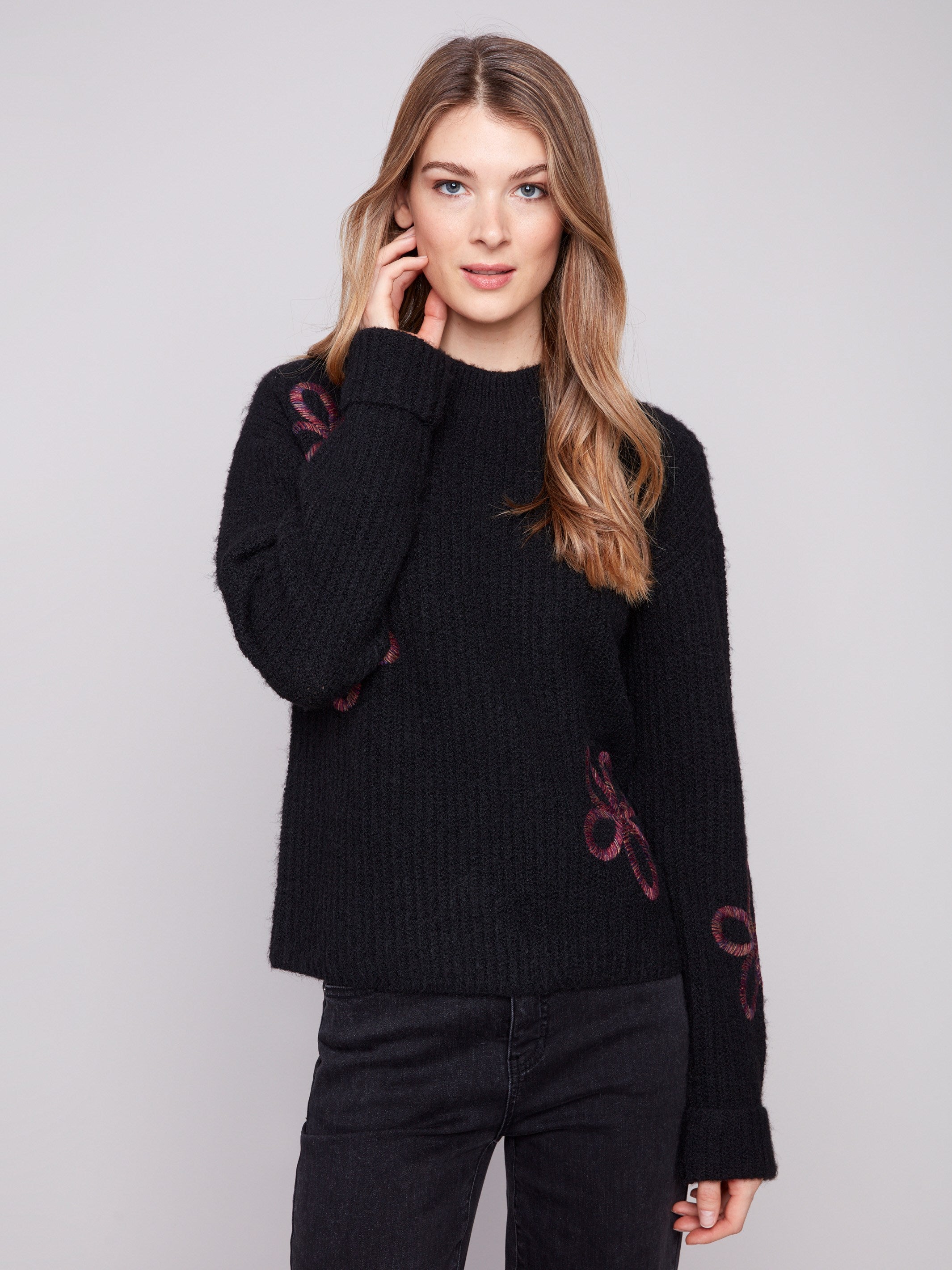 Sophisticated black sweater with relaxed fit and beautiful floral soutache embellishments by Charlie B.