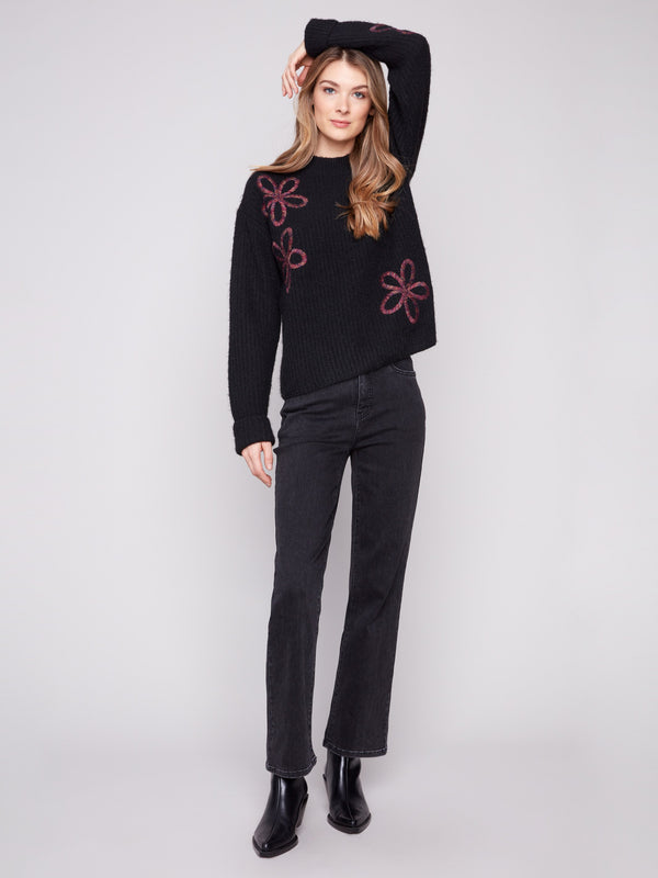 Stylish black sweater adorned with wide cuffs and delicate floral soutache embroidery by Charlie B.