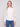 Ecru sweater with a sophisticated mock neck, emphasizing its chic and contemporary style by Charlie B.