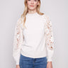Ecru sweater with a sophisticated mock neck, emphasizing its chic and contemporary style by Charlie B.