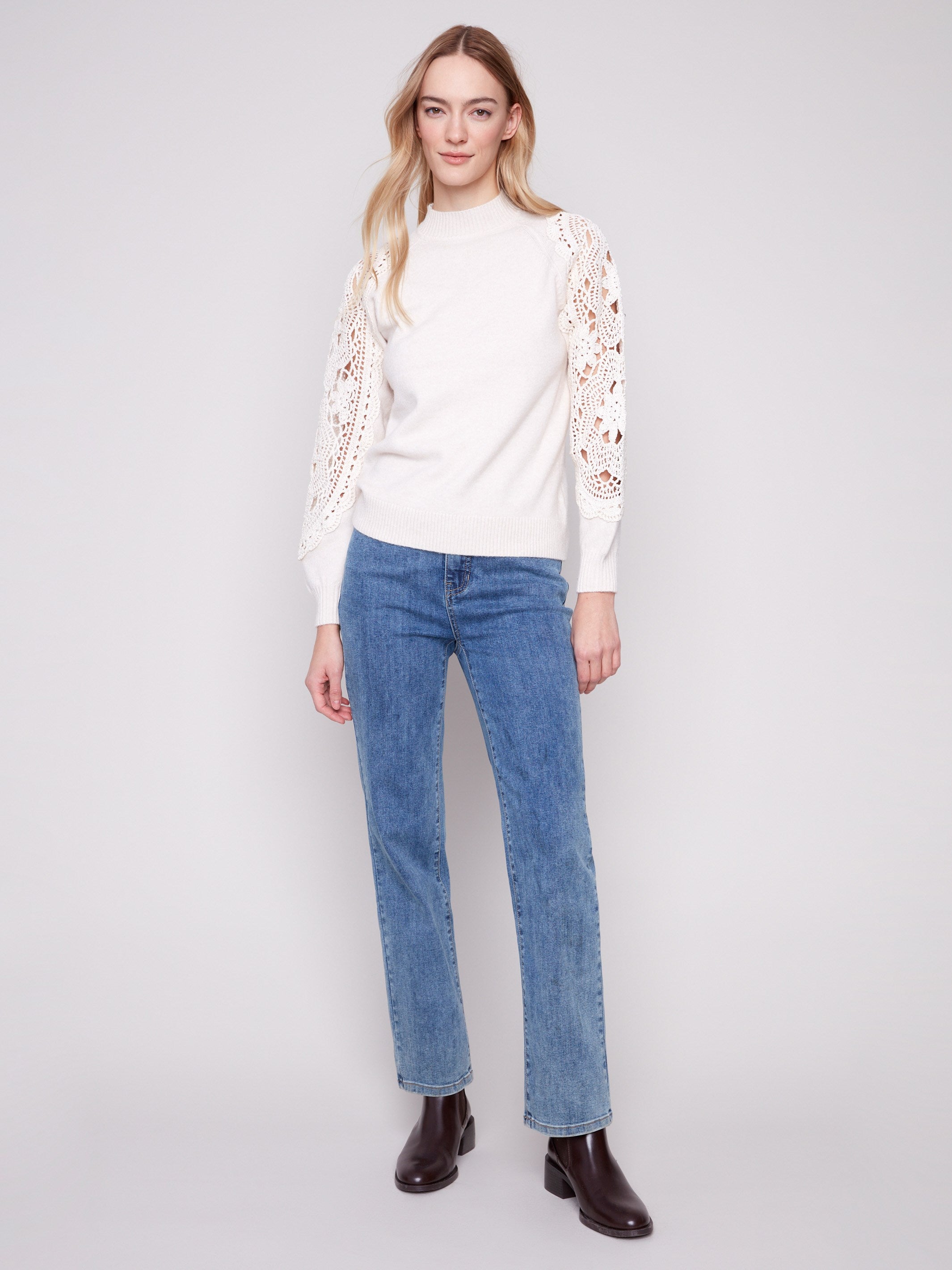 Elegant ecru sweater featuring exquisite crochet sleeves, adding a touch of artistry by Charlie B.