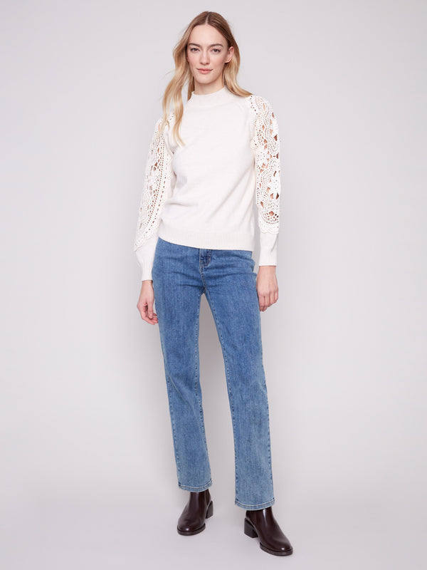 Elegant ecru sweater featuring exquisite crochet sleeves, adding a touch of artistry by Charlie B.