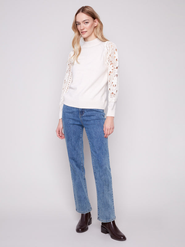 Stylish ecru mock neck sweater with beautiful crochet detailing, perfect for any occasion by Charlie B.