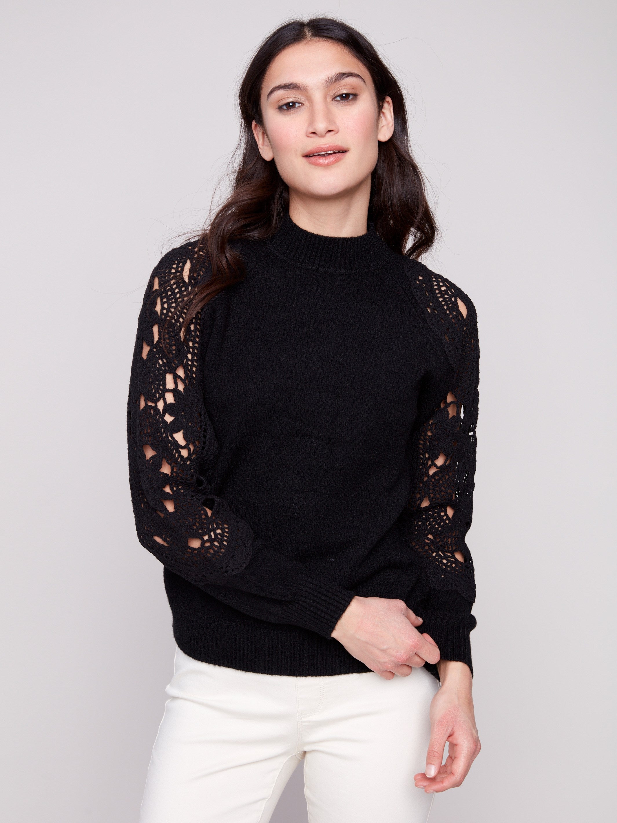 Elegant black sweater featuring a mock neck, perfect for a chic and modern look by Charlie B.