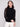 Elegant black sweater featuring a mock neck, perfect for a chic and modern look by Charlie B.