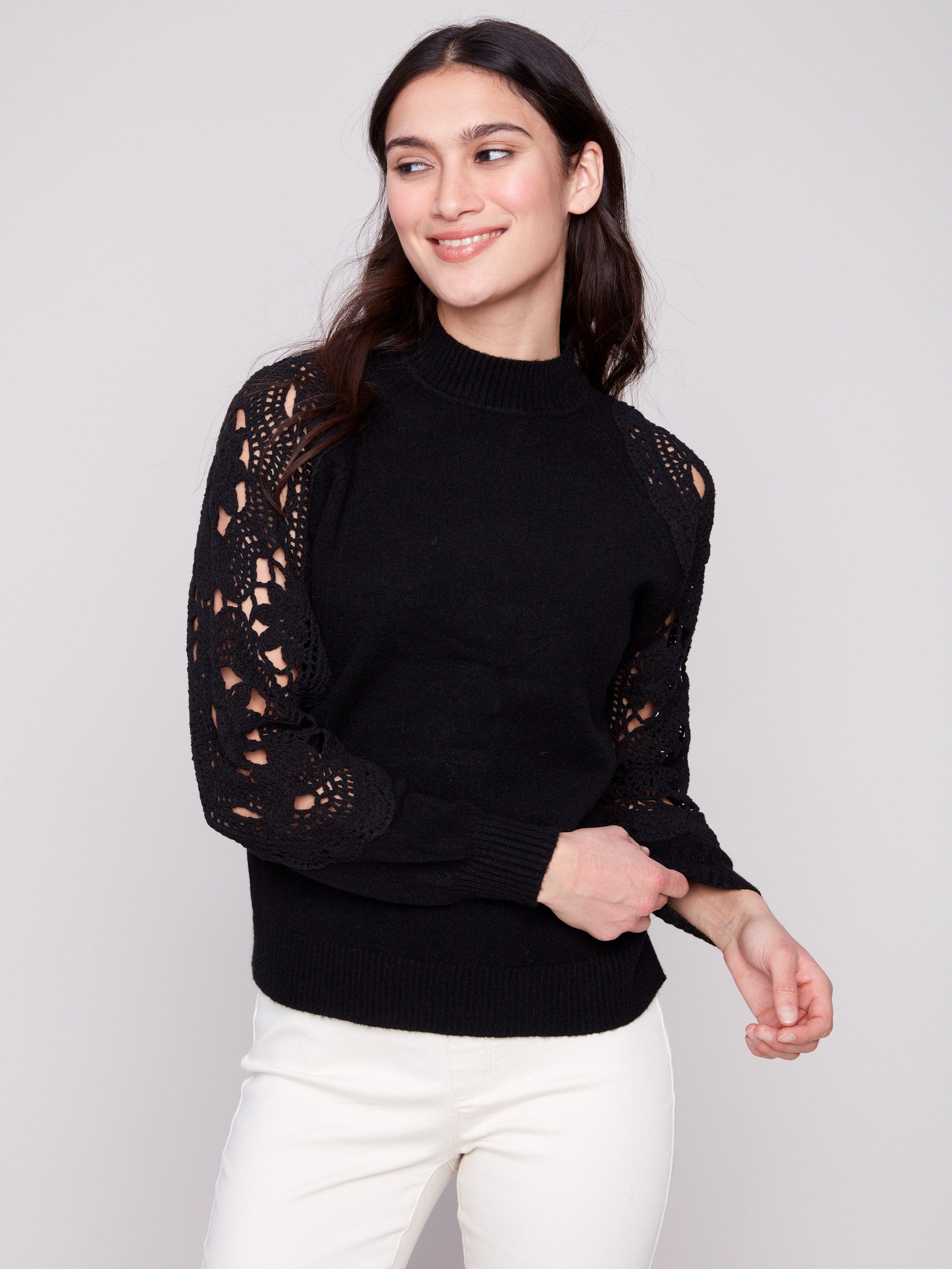 Black sweater with ribbed cuffs that provide comfort and style, ideal for any occasion by Charlie B.