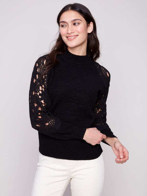 Black sweater with ribbed cuffs that provide comfort and style, ideal for any occasion by Charlie B.
