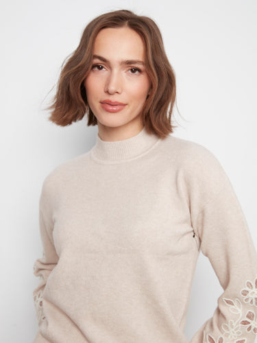 Mock neck sweater in soft fabric, highlighted with embroidered floral patterns on sleeves by Charlie B.