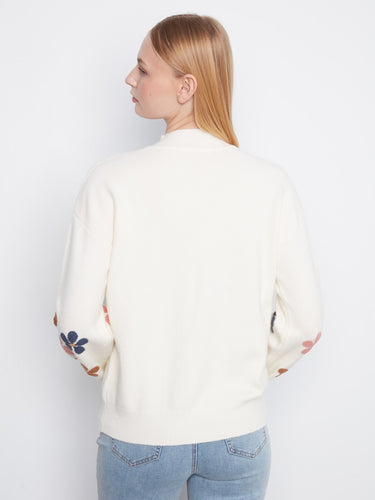 Ribbed cuffs and hem offer a snug fit while maintaining comfort and style. The embroidered flowers add a playful touch by Charlie B.