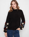 Black sweater featuring long balloon sleeves with floral embroidery, adding a playful touch by Charlie B.