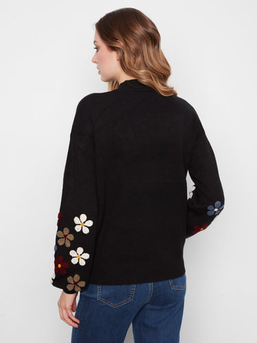 Stylish black sweater adorned with intricate floral sleeve embroidery, perfect for any occasion by Charlie B.