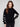 Elegant black sweater with a chic mock neck design, featuring white heart details on sleeves by Charlie B.