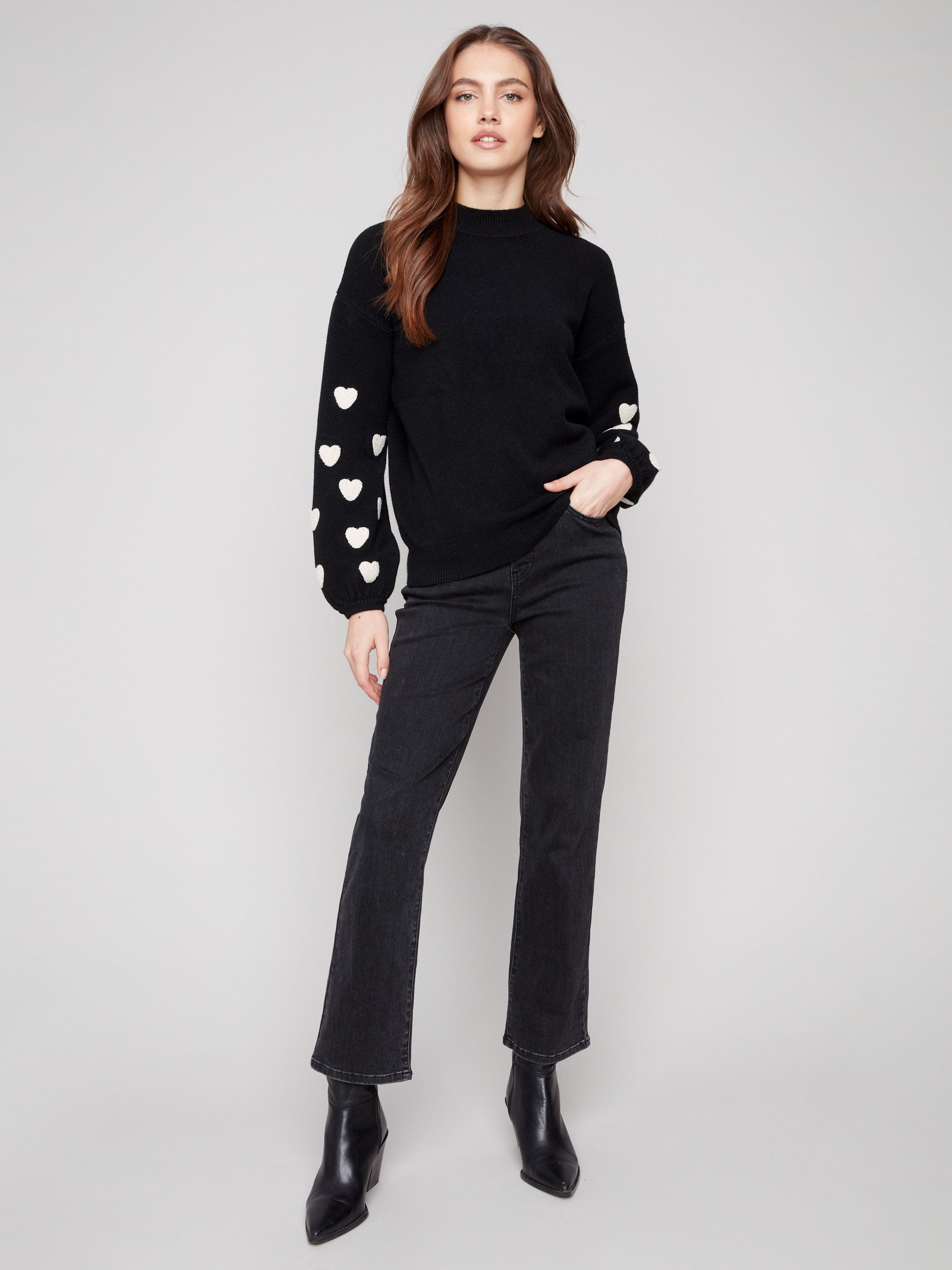 Stylish drop shoulder sweater in black with intricate white heart embroidery for a unique touch by Charlie B.