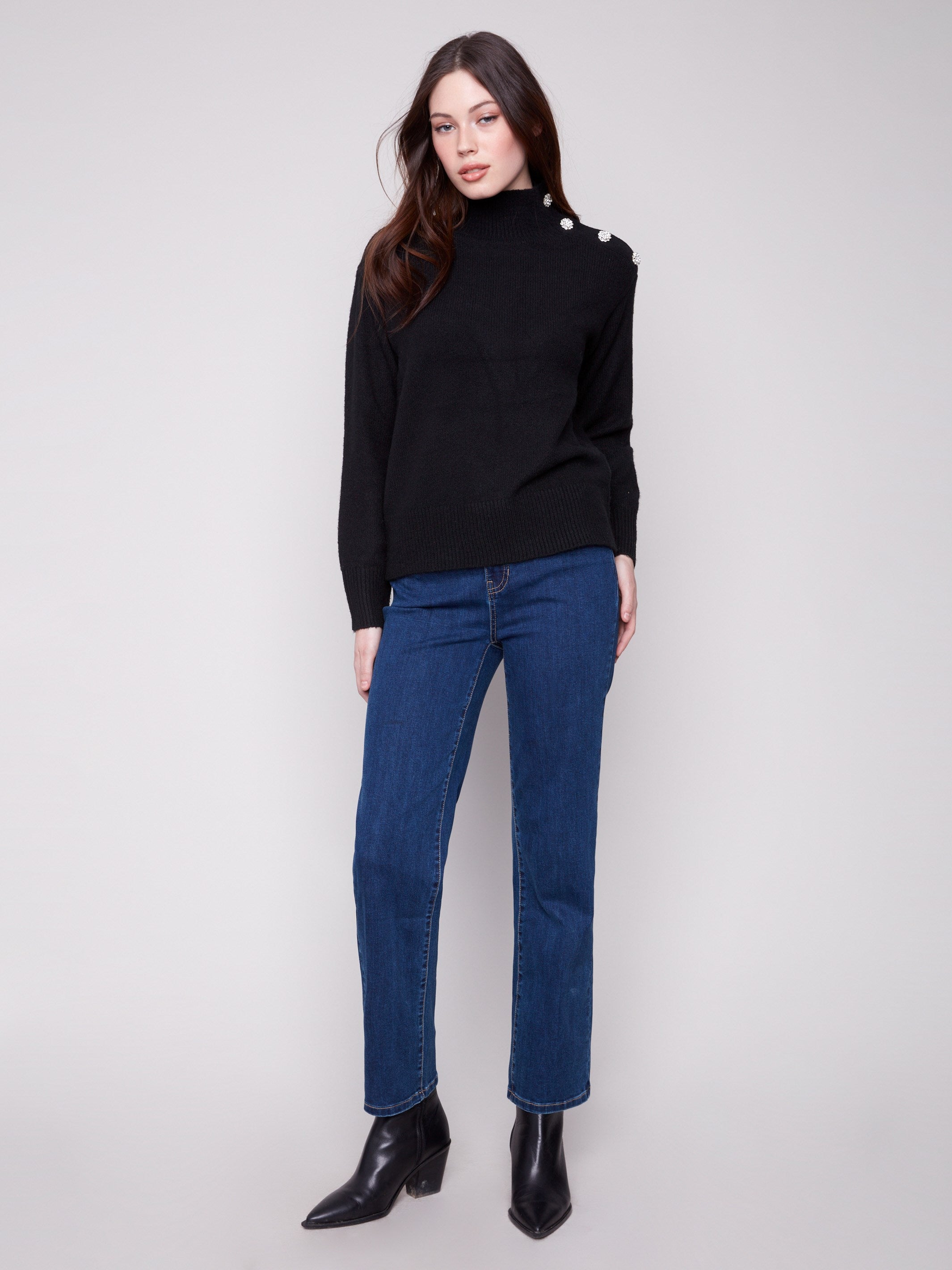 Chic black sweater featuring fancy buttons at the neck, adding a touch of sophistication by Charlie B.