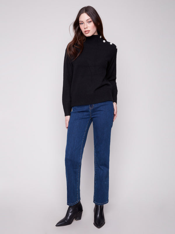 Chic black sweater featuring fancy buttons at the neck, adding a touch of sophistication by Charlie B.