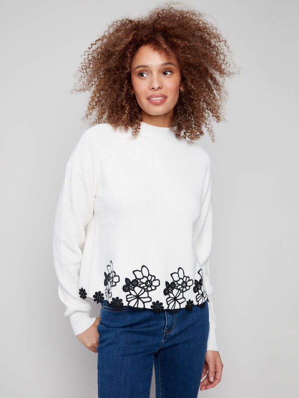 Ecru sweater with drop shoulder design and black floral lace hem, perfect for a chic look by Charlie B.