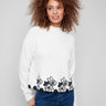Ecru sweater with drop shoulder design and black floral lace hem, perfect for a chic look by Charlie B.