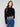 Black sweater featuring a mock neck and elegant drop shoulder design, highlighted by floral lace hem by Charlie B.