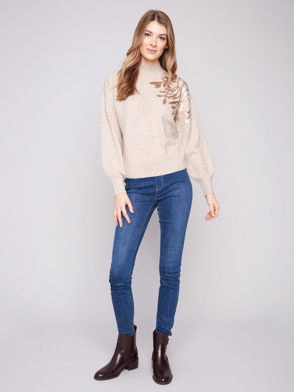 Cozy knit cuffs complement the mock neck and embroidered design of this stylish heather oat sweater by Charlie B.